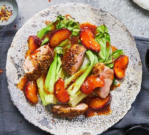 One-pan coriander-crusted duck, roasted plums and greens