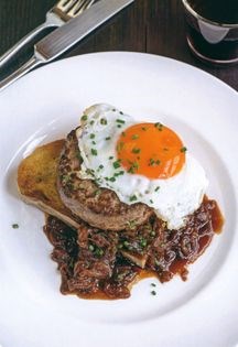 Open burger on sourdough with onion gravy and fried egg
