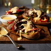 Open-face Philly cheesesteak sandwiches