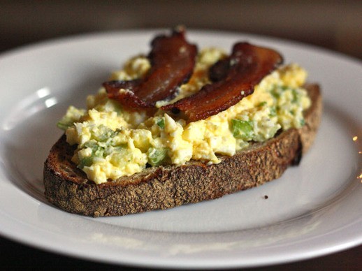 Open-faced egg salad sandwich with bacon