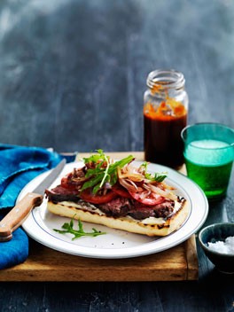 Open steak sandwich with onions and barbecue sauce