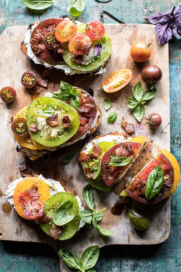 Opened faced tomato and goat cheese sandwich with hot bacon vinaigrette