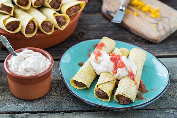 Orange-black bean taquitos with spiked “sour cream”