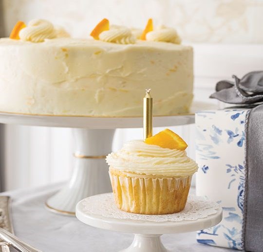 Orange cake with orange buttercream frosting [citrus simple syrup]