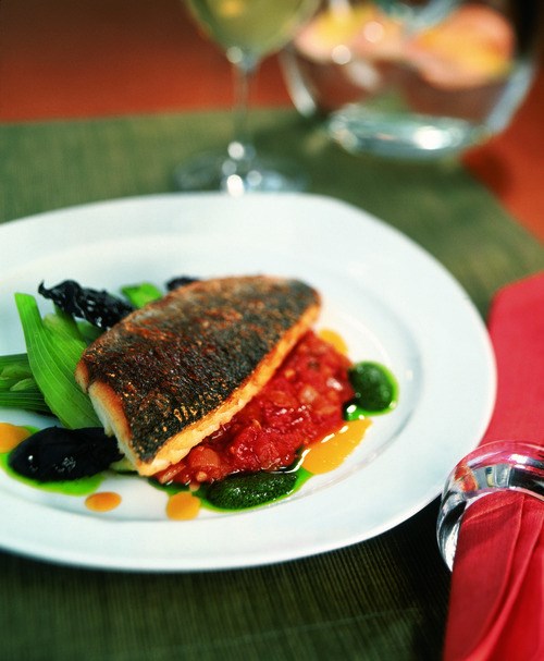 Orange-glazed sea bream with tomato, pesto, and fennel