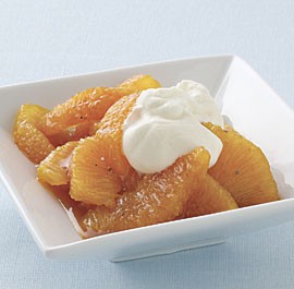 Oranges in cardamom syrup with honey whipped cream