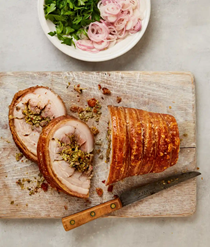 Oregano-stuffed porchetta with pickled shallots