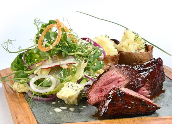 Organic chargrilled hanger steak, loaded potato skins, baby gem and blue cheese salad