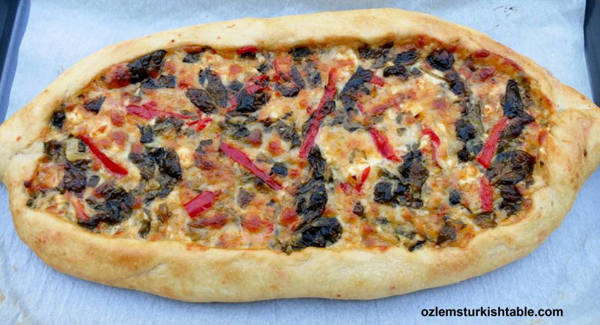 Oval flat breads with cheese, peppers, onion and spinach (Peynirli, sebzeli pide)