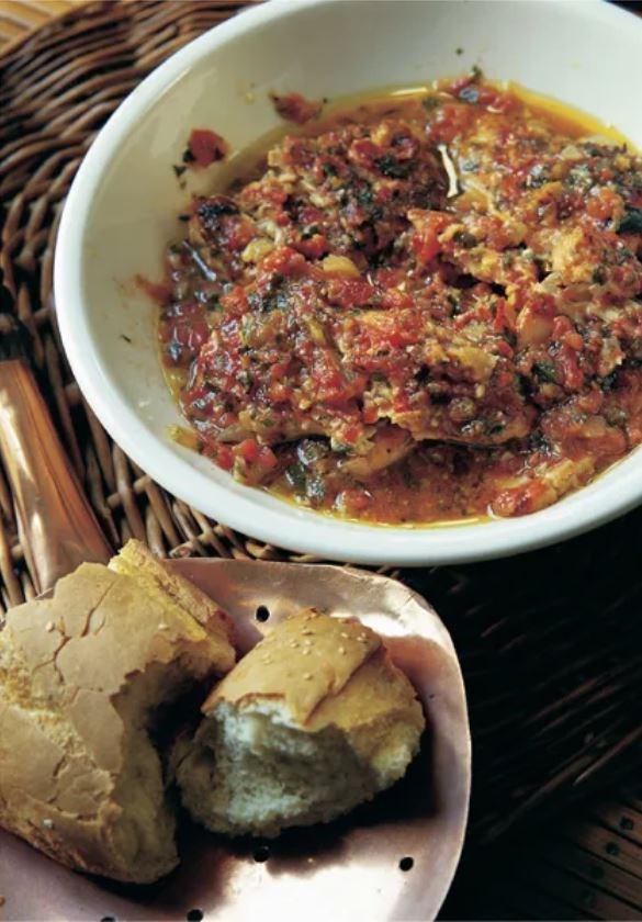Oven-baked fish with tomato and parsley