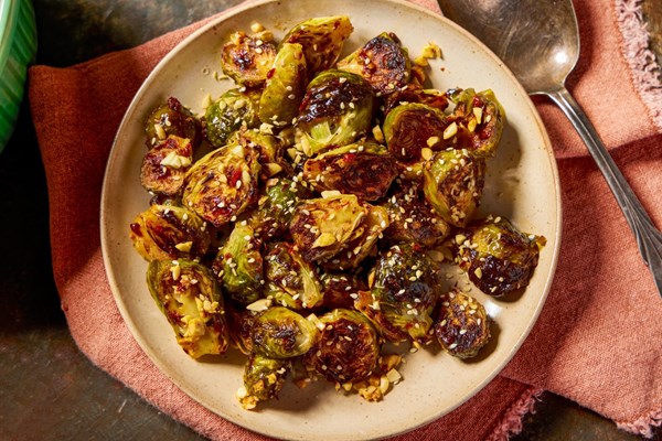 Oven-charred Brussels sprouts with chipotle chilies and peanuts