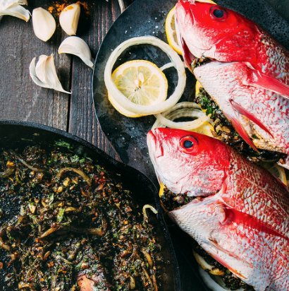 Oven-roasted fish with onion, lemon, fenugreek & cilantro (Mahi-e shekam por)
