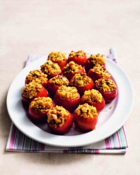Paella-stuffed tomatoes