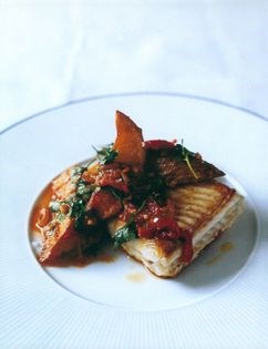 Pan-fried fish with patatas bravas