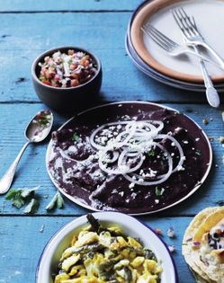 Pan-fried tortillas in a spicy black bean sauce (Enfrijoladas)
