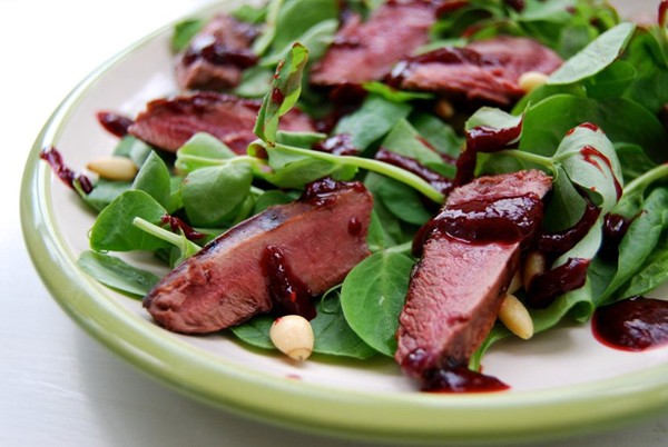 Pan fried wood pigeon salad with a fresh raspberry balsamic reduction