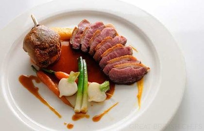 Pan roast duck with sweet potato fondant, baby vegetables and cherry brandy sauce