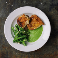 Pan-roasted chicken thighs with blitzed pea sauce and sugar snap pea salad