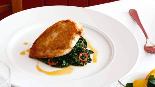 Pan-roasted chicken with chilli and anchovy braised cavolo nero and sautéed sage potatoes