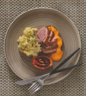 Pan-roasted duck breast on lime leaf and peanut mash with mango dressing and roast tamarillo