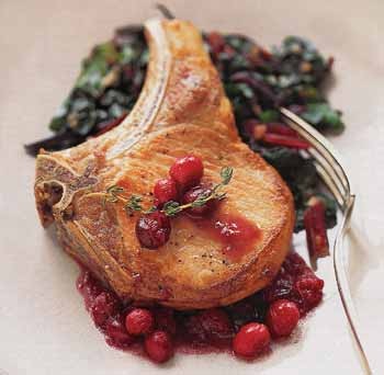 Pan-roasted pork chops with cranberries and red Swiss chard