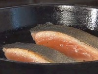 Pan-roasted salmon with green beans, yellow pear tomatoes, and basil oil