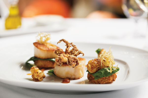 Pan-roasted sea scallops, sautéed & crisp calamari, arancini with ponzu gel, spiced potatoes & spinach salad
