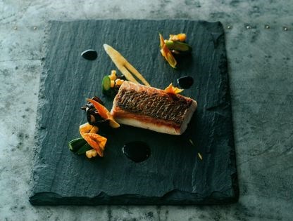 Pan-roasted snapper with sweet corn, zucchini flowers, black fungus & cuttlefish ink