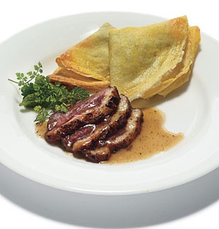 Pan-seared duck breast with duck confit and collard-stuffed crepes