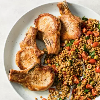 Pan-seared pork chops with warm lentil salad