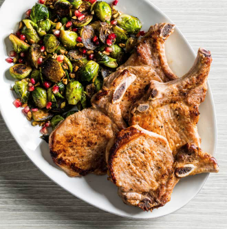 Pan-seared pork chops with blistered Brussels sprouts and pomegranate