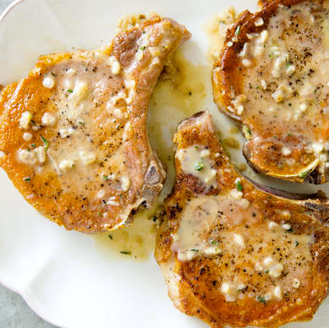 Pan-seared thick-cut pork chops with garlic and thyme pan sauce