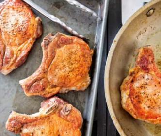 Pan-seared thick-cut pork chops with garlic and thyme pan sauce