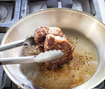 Pan-seared thick-cut strip steaks with sun-dried tomato relish