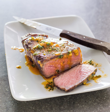 Pan-seared thick-cut strip steaks with Thai chili butter