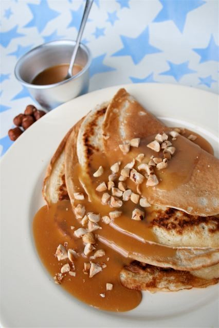 Pancakes with hazelnuts and hot maple fudge sauce