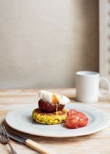 Paneer and turmeric corncakes with roast mushrooms, tomato and poached eggs