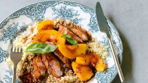 Panfried duck breasts with peaches, basil and balsamic gravy