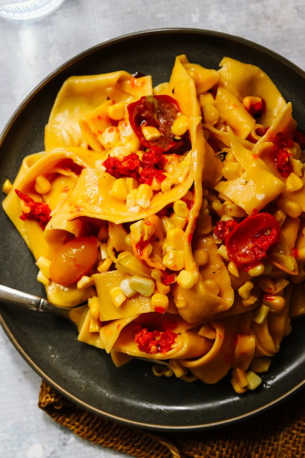 Pappardelle pasta with corn, cherry tomatoes, and Parmesan