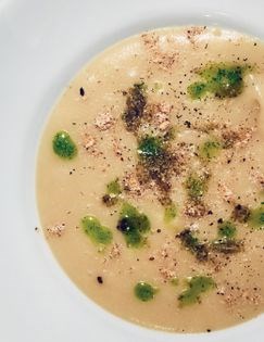 Parsnip apple soup with curry, celery oil & smoked almonds