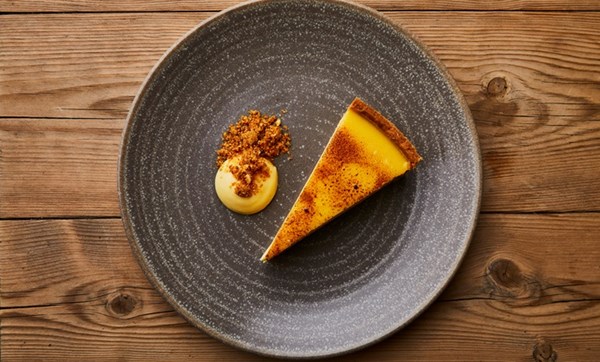 Passion fruit tart, lemon curd sauce and hazelnut praline