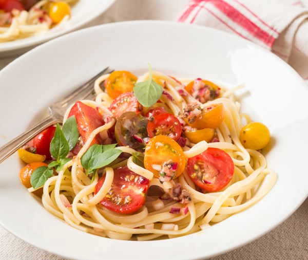Pasta fredda with cherry tomatoes, anchovies and herbs