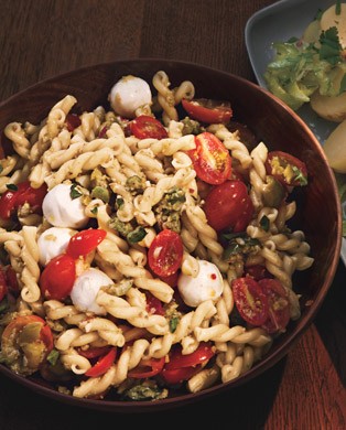 Pasta salad with cherry tomatoes and green olivada