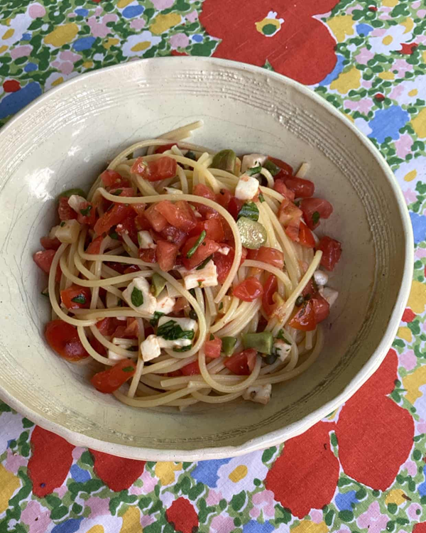 Pasta with a raw tomato, mozzarella, herb and olive sauce