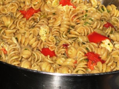 Pasta with pesto, chicken, peppers, and tomatoes