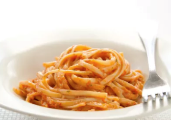 Pasta with tomato, pine nut, and arugula pesto
