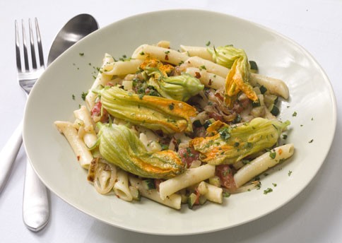 Pasta with zucchini, zucchini blossoms, and caramelized onion