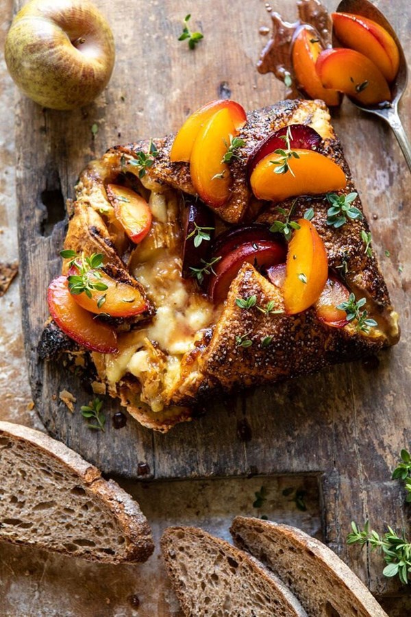 Pastry wrapped baked Brie with thyme butter roasted plums