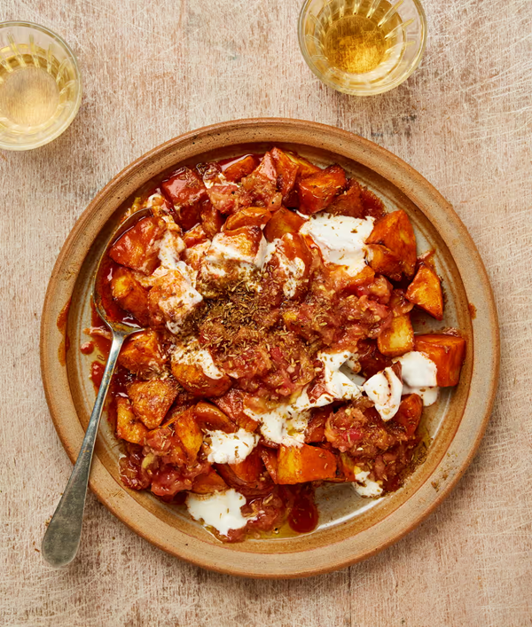 Patatas bravas with grated tomato and cumin