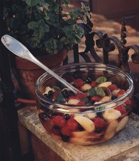 Peaches, raspberries and blueberries with Prosecco